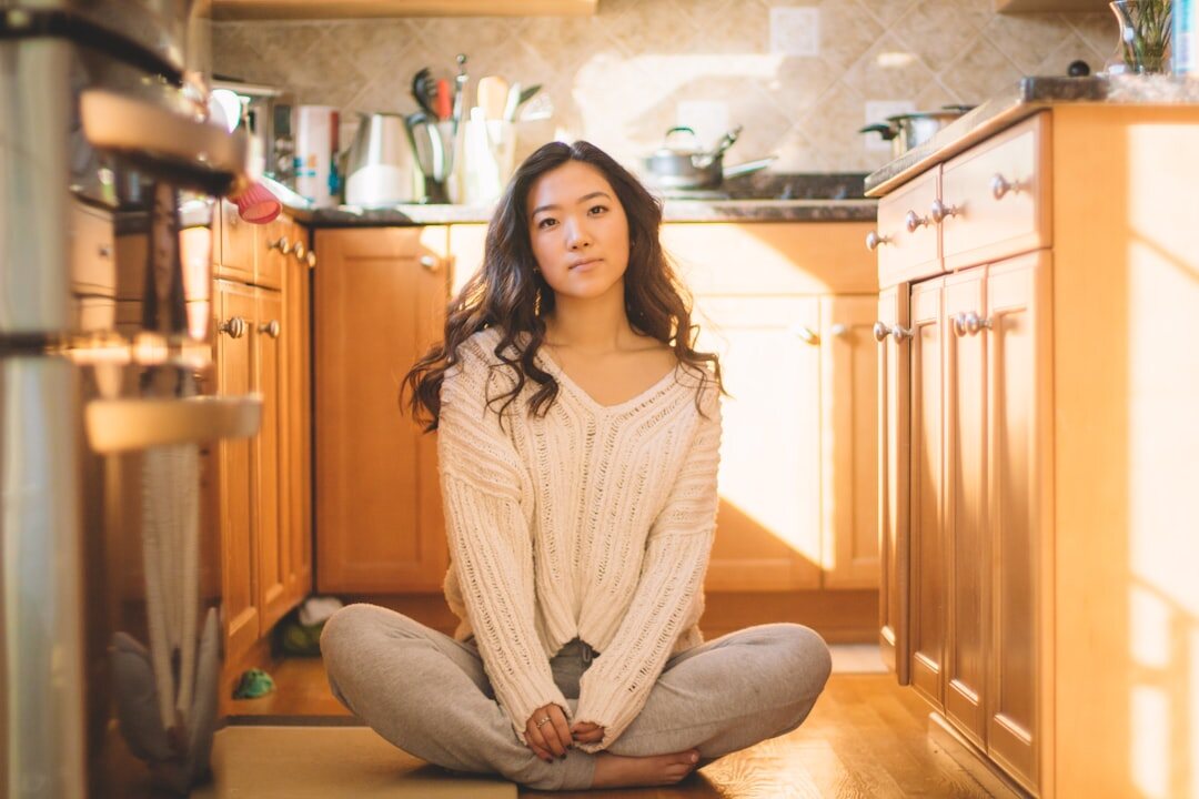 Woman sitting calmly with eyes closed breathing