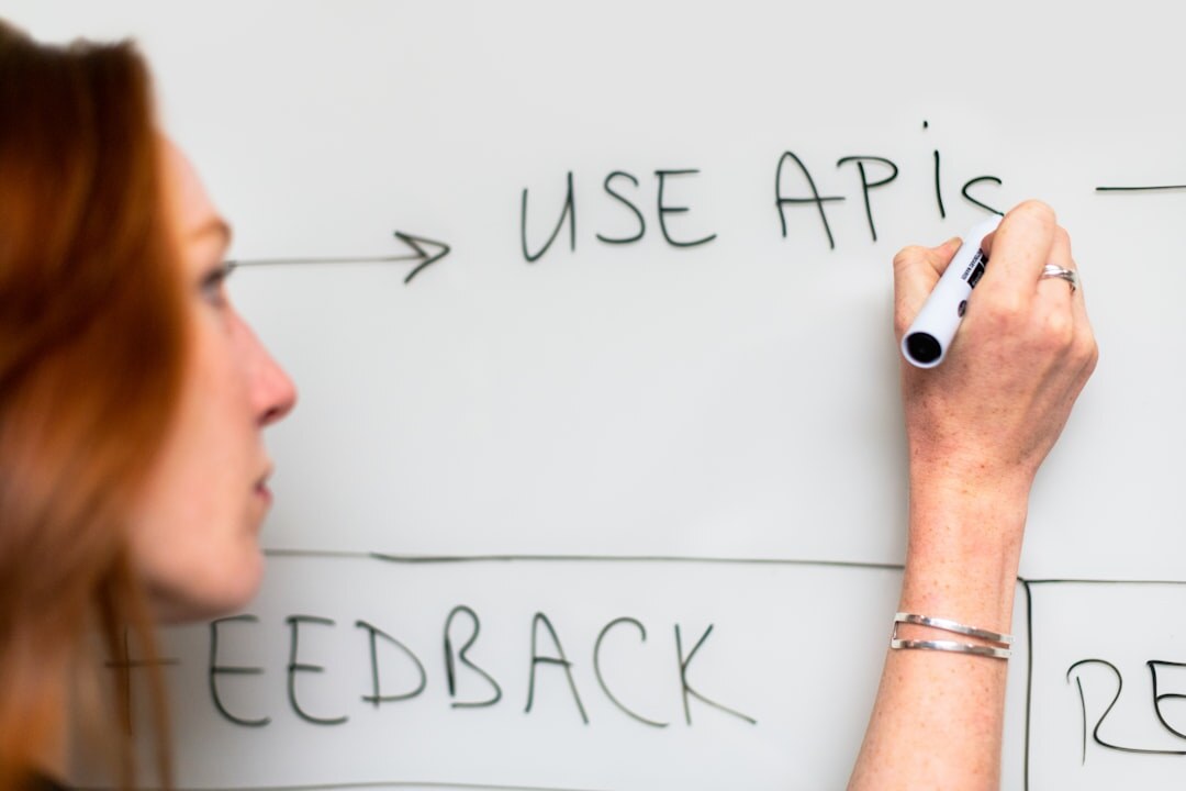 Person writing on a whiteboard with diagrams