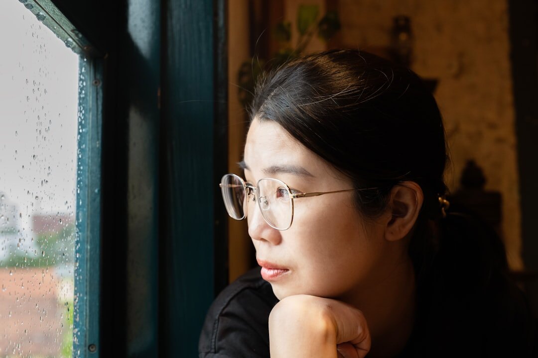 Person looking out of a window thoughtfully