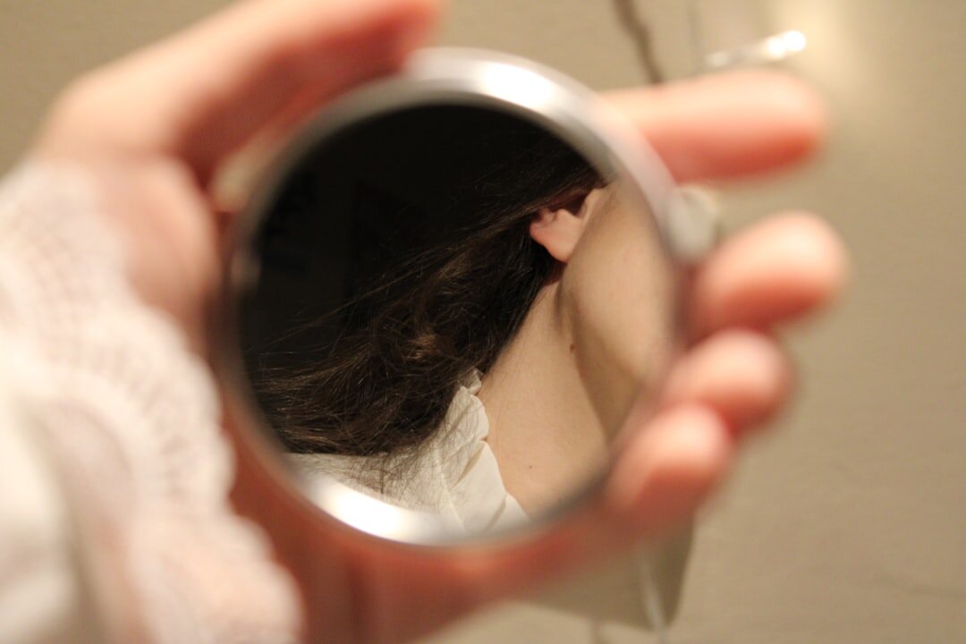 person reflecting in mirror
