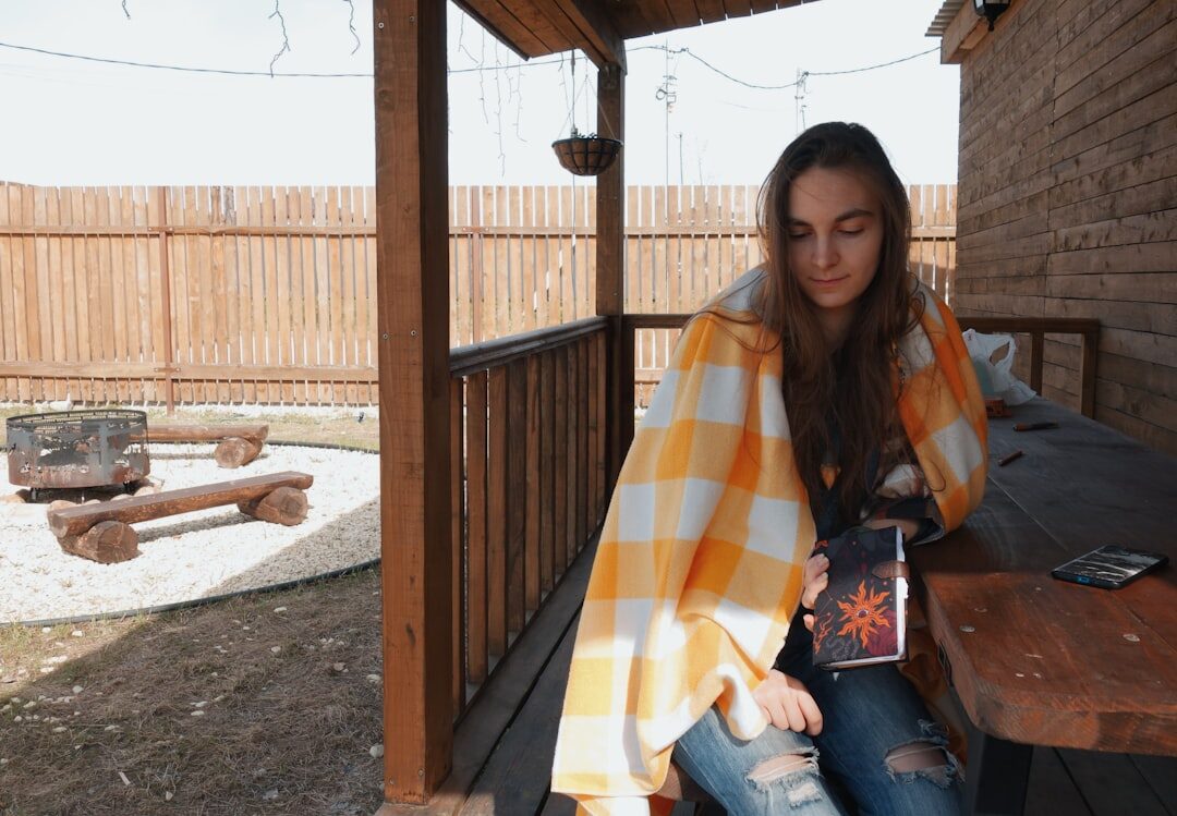 person reading book outdoors