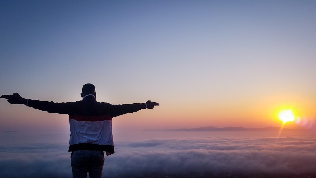 person meditating at sunrise