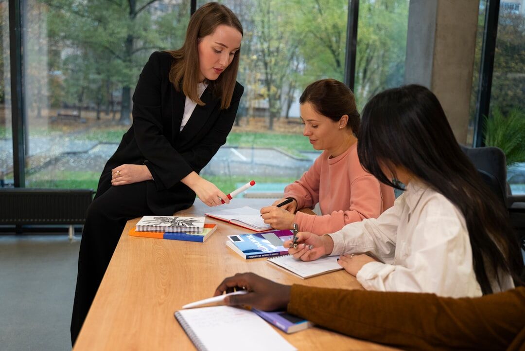 Small group collaborating around a table with notebooks