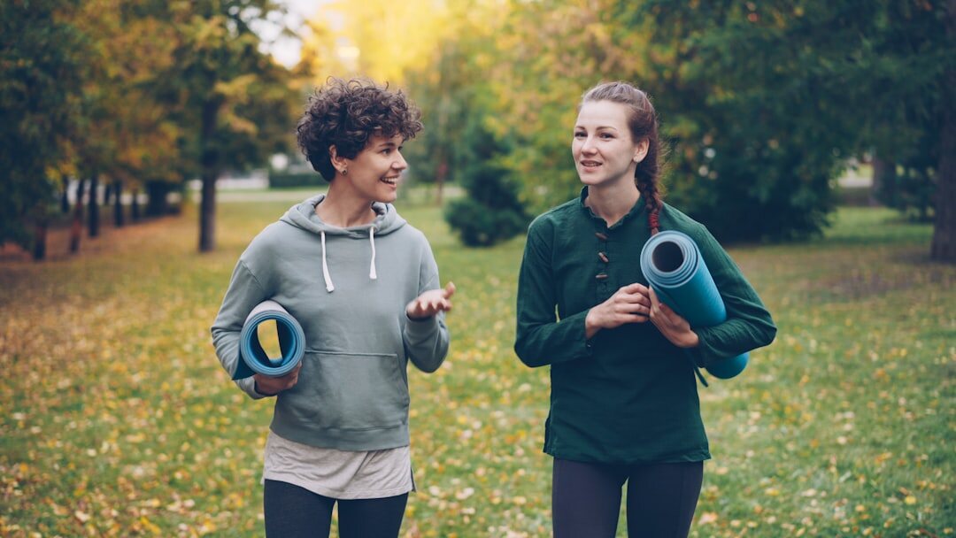 Two people walking and talking outdoors